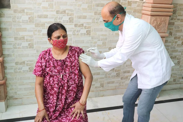 Vaccination in india, Medical worker or doctor giving vaccine injection to a mature woman at hospital to protect from coronavirus or covid-19. COVISHIELD / COVAXIN Dose. Vaccination in india, Medical worker or doctor giving vaccine injection to a mat
