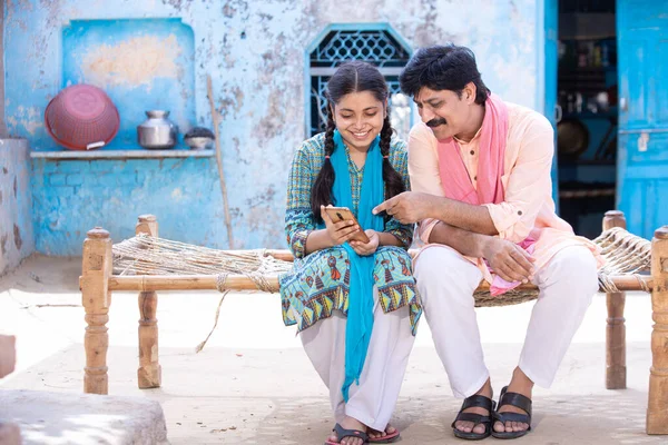 Happy Indian Father Young Daughter Using Smartphone While Sitting Traditional Stock Picture