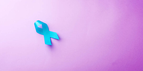 November light blue ribbon, studio shot isolated on purple background, Prostate cancer awareness month, men 's health concept