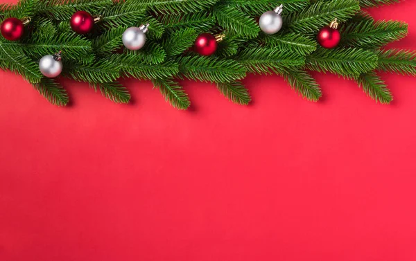 圣诞背景介绍圣诞贺卡 上面有俯瞰的冷杉树枝和装饰品 圣诞佳节的背景是红色桌子 还有复制空间 — 图库照片