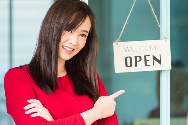 New normal, Asian young woman glad and smiling point finger to notice sign wood board label \