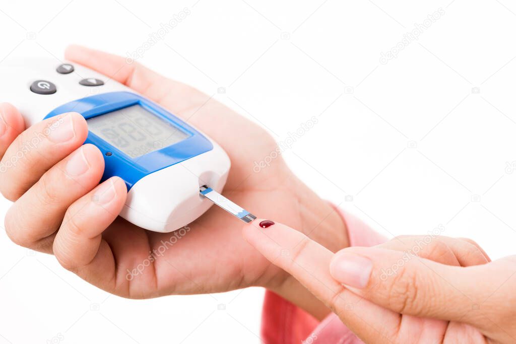 Closeup hands woman measur glucose test level check with blood on finger by glucometer she monitor and control high blood sugar diabetes and glycemic health care concept isolated on white background