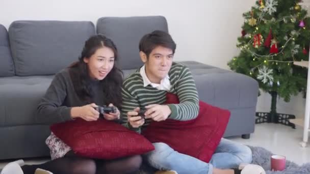 快乐的亚洲年轻夫妇夫妻笑着 笑着和对方一起玩电子游戏 — 图库视频影像