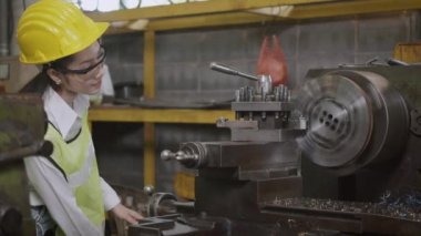 Asyalı profesyonel makine mühendisi ya da gözlük takan operasyon kadını güvenlik atölye metal torna fabrikasında çalışıyor ağır sanayi işçisi kadın.