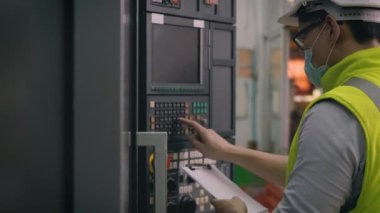 Asyalı fabrika işçisi otomatik programlama CNC değirmen kontrol makineleri sanayi merkezi araç imalat atölyesinde