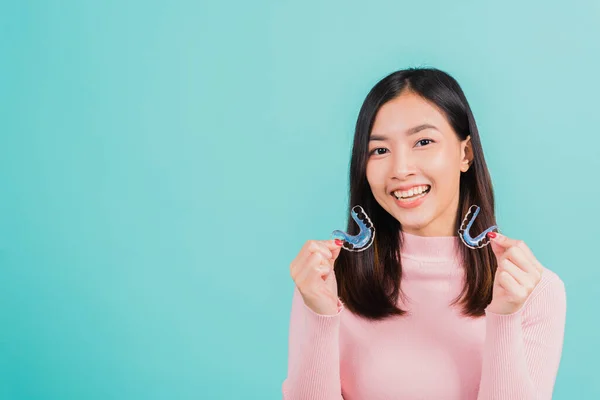 肖像アジアの美しい若い女性の笑顔は歯のためのシリコーン歯列矯正家臣を保持し 取り外し可能なブレース 隔離された青の背景の後の歯の保持ツール 歯科衛生健康的なケアの概念 — ストック写真