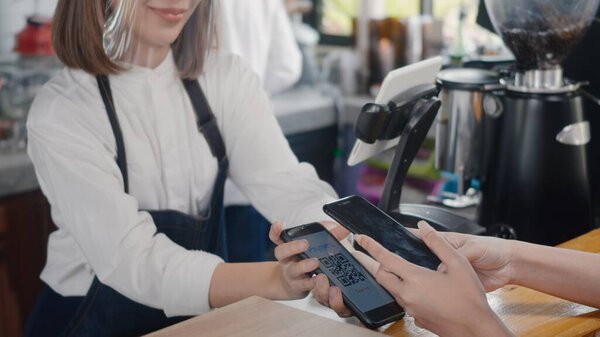 QR code payment, customer woman using digital smartphone application scanning QR code payment without money for buying coffee in cafe coffee shop, small business accepts digital payment