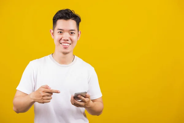 Asian Handsome Young Man Smiling Positive Holding Smartphone Blank Screen —  Fotos de Stock