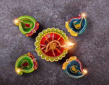 Üst tepedeki kil Diya 'da ya da petrol lambasında ateş yaktı, stüdyo çekimleri arka planda, Hinduizm Rangoli Dekorasyonu, Deepavali ya da Diwali Festivali' nde Mutlu Kutlamalar konsepti