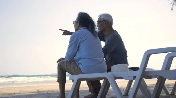 幸せなアジアの家族は 高齢者のカップルが一緒に話してビーチ旅行休暇に背を向けて椅子に座って ロマンチックな高齢者をお楽しみください旅行夏休み 計画生命保険退職カップルのコンセプト — ストック写真