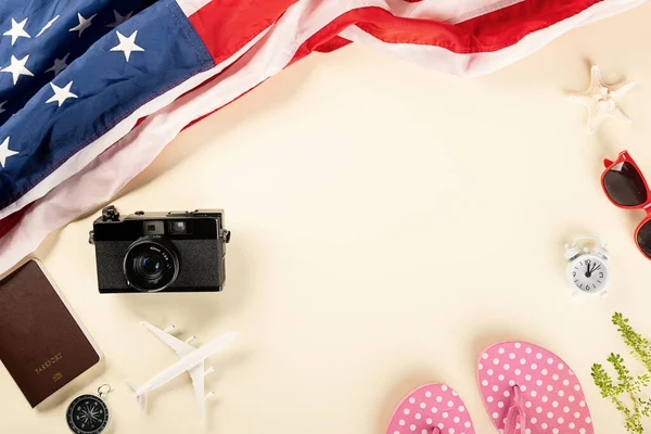 World Tourism Day, Top view model plane, camera and American flag, Holiday accessory beach trip travel vacation flight visa to USA is opened after coronavirus