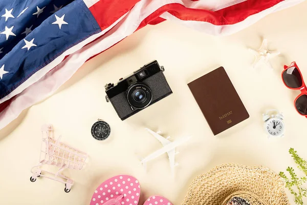 World Tourism Day, Top view model plane, camera and American flag, Holiday accessory beach trip travel vacation flight visa to USA is opened after coronavirus