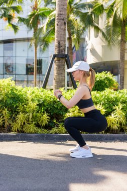 Genç kadın spor egzersizleri, sağlıklı yaşam tarzı için esneme hareketleri, güçlü vücut geliştirme amaçları için bir başka dinamik gerinme hareketi..
