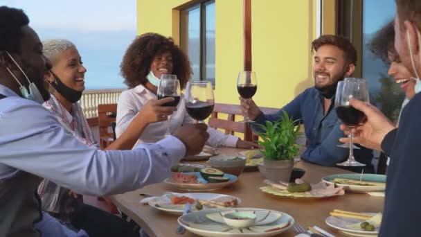 Young Multiracial Friends Toasting Red Wine Glasses While Wearing Face — Stock Video