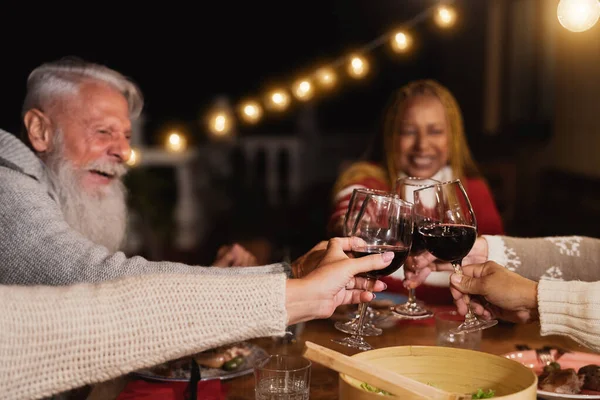 Happy Multiracial Seniors Toasting Red Wine Glasses Celebrating Holidays House — Stok Foto