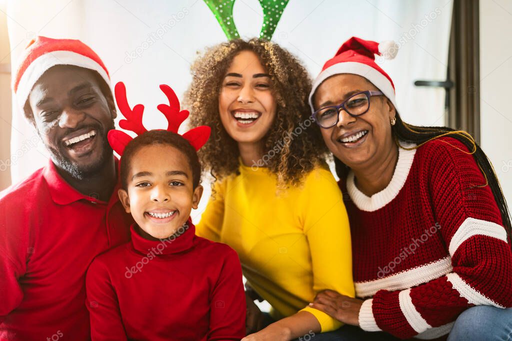 Happy African family having fun together celebrating Christmas holidays