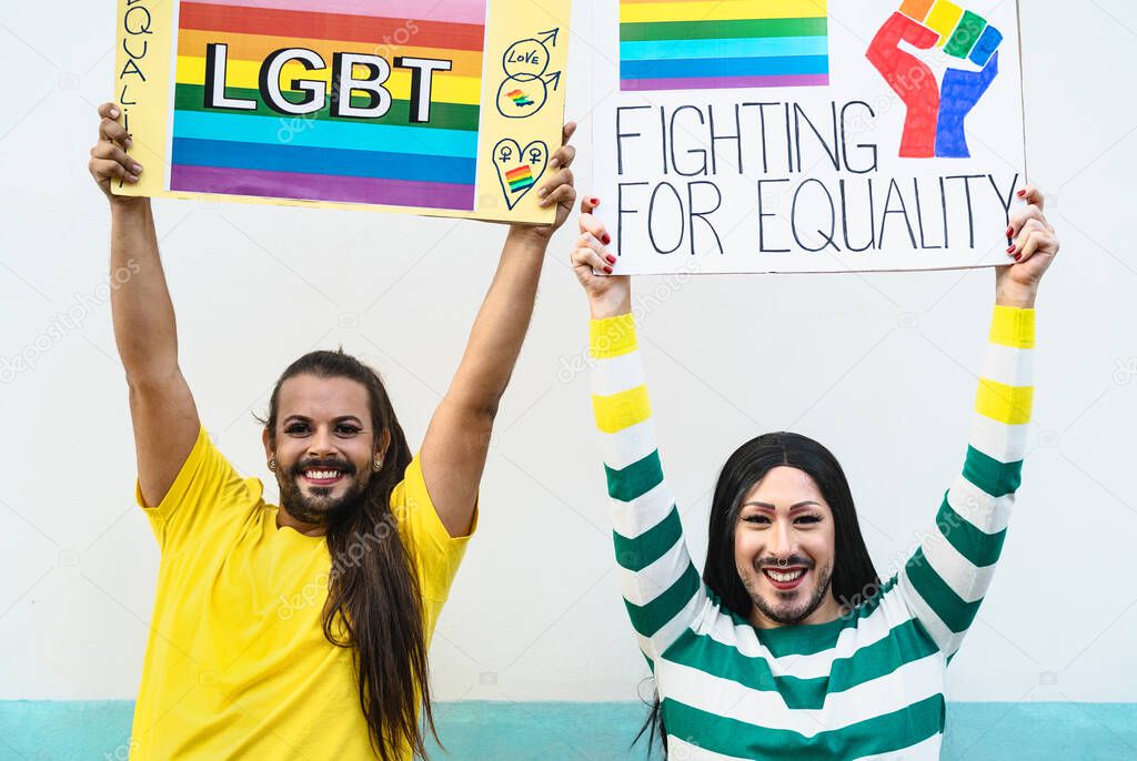 Happy drag queen activists protesting during gay pride parade - LGBT social movement concept