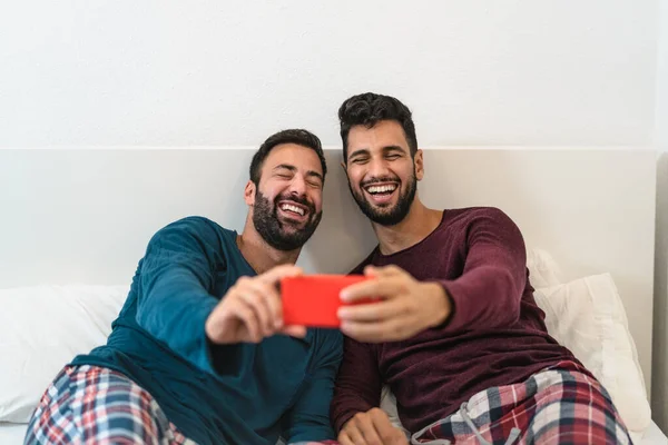 Happy Gay Couple Having Fun Using Mobile Smartphone Bed Homosexual — Stock Photo, Image