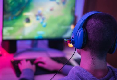 Young gamer playing online video games while streaming on social media - Youth people addicted to new technology game clipart