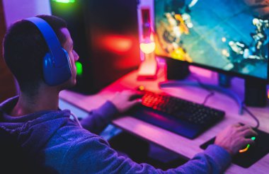 Young gamer playing online video games while streaming on social media - Youth people addicted to new technology game clipart