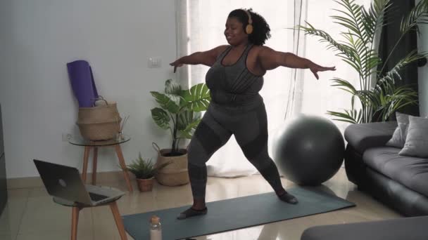 在家里用笔记本电脑做普拉提虚拟健身课的年轻非洲妇女 体育健康人士生活方式概念 — 图库视频影像