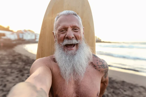 Happy Senior Surfer Taking Selfie While Having Fun Surfing Sunset — Stok Foto