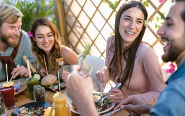 Sağlıklı öğle yemeği yiyen ve cafe brunch restoranında taze meyve püresi içen mutlu genç arkadaşlar - sağlıklı beslenme yaşam tarzı konsepti