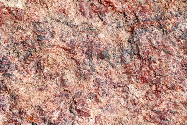 赤い色でカラフルなクローズ アップみかげ石のテクスチャ. — ストック写真