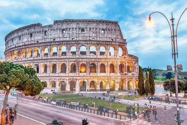 Exterior of the Flavian Amphitheatre, aka Colosseum in Rome at dusk, Italy
