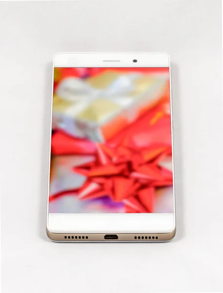 Modern smartphone displaying full screen picture of Christmas gifts — Stock Photo, Image