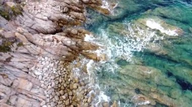 Okyanus dalgalarının hava manzarası, İtalya 'nın kuzeyindeki Santa Teresa Gallura' nın en güzel sahil noktalarından birini süsleyen kayalık kıyı şeridini vuruyor.