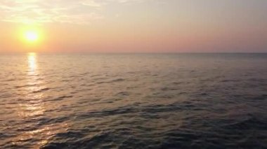 Flying fast over the sea towards a beautiful sunset in Calabria, Italy