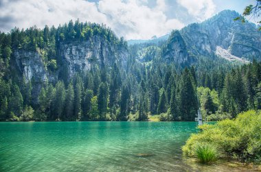 Güneşli bir yaz gününde arka planda Brenta Dolomitleri olan güzel Tovel gölünün panoramik manzarası, Trentino Alto Adige, İtalya