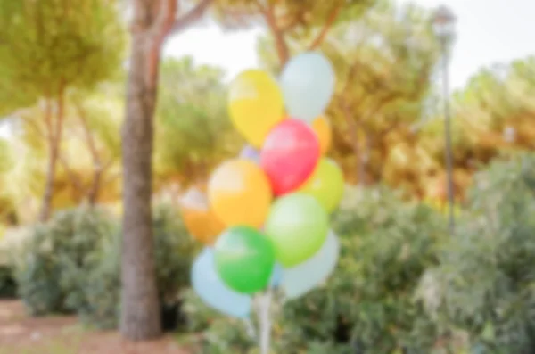 Defocused background with colorful bunch of helium balloons — Stock Photo, Image