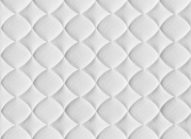 Beyaz, pürüzsüz desen. Kumaş kıvırcık bir desenle dikilmiş. Yatak için yatak.