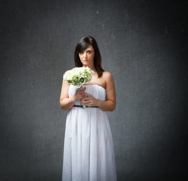 Sad bride with flowers — Stock Photo, Image