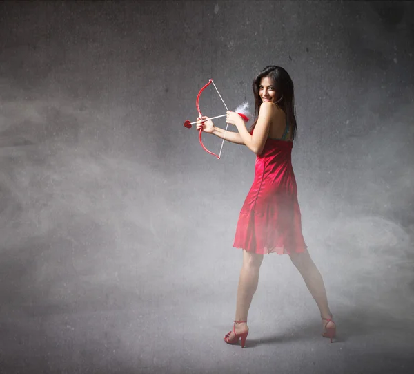 Woman in red with arrow — Stock Photo, Image