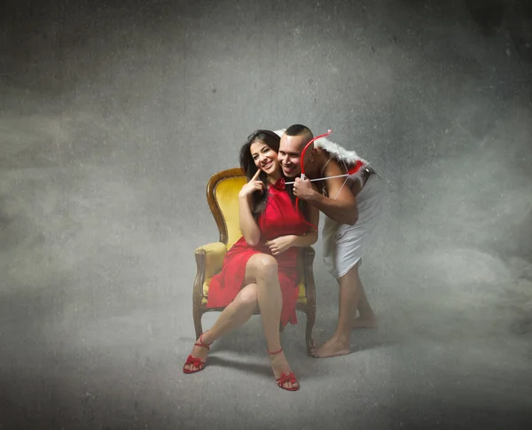 Man cupid with woman in red — Stock Photo, Image