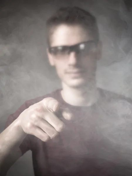 Man indicated in a cloud of smoke — Stock Photo, Image