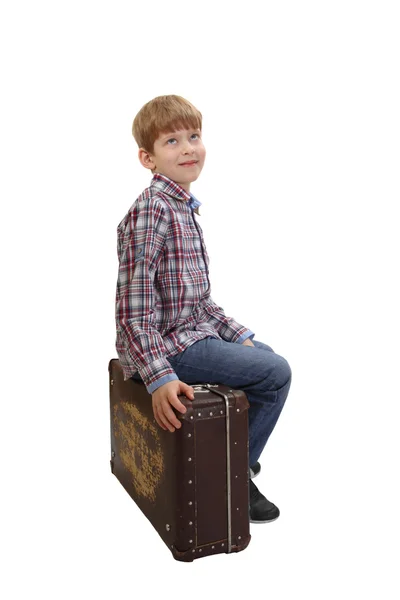 Boy sits on vintage suitcase — Stock Photo, Image