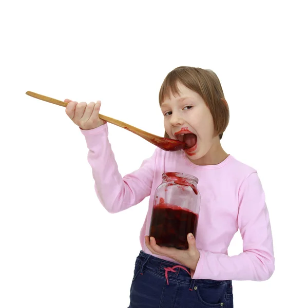 Menina comendo geléia do frasco — Fotografia de Stock