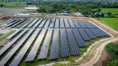 Modern bir güneş çiftliği üzerinde hava manzarası. Küresel ekosistem kavramında yeşil enerji toplamak için güneş panelleri istasyonu.