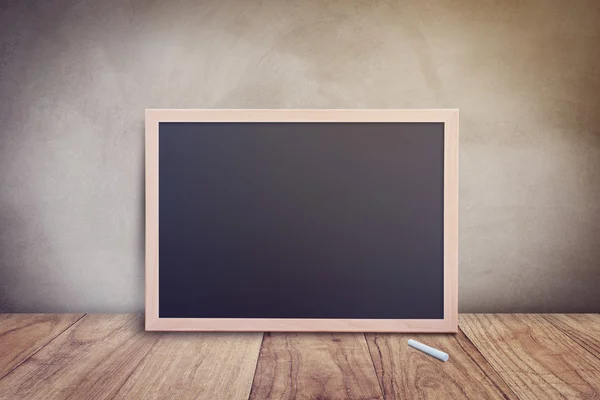 Blank chalkboard centre of wall — Stock Photo, Image