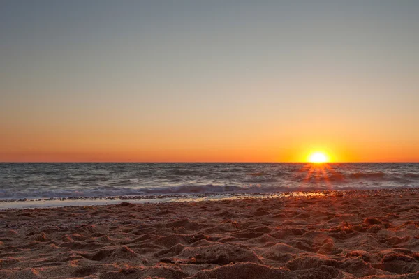 A beautiful sunset on a sandy beach in Kacha. — Stock Photo, Image