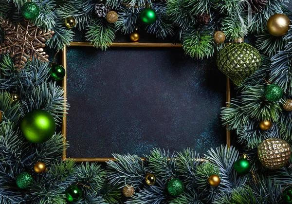 Christmas composition. Frame with pine branches and Christmas decorations on green background. Christmas, winter, new year concept. Flat lay, top view, copy space.