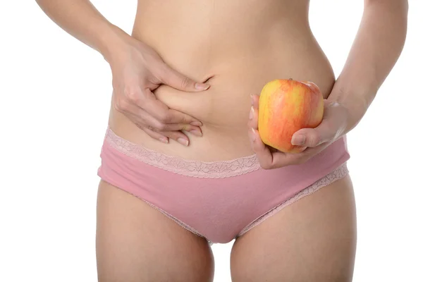 Mulher magra bonita segurando maçã enquanto verifica sua gordura, Dieta c — Fotografia de Stock