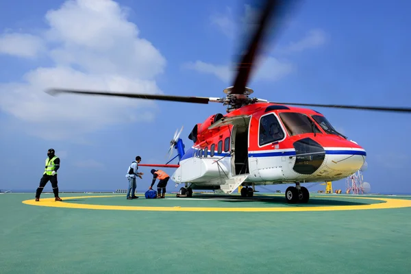 The officer take care passenger and load baggage to helicopter a — Stock Photo, Image