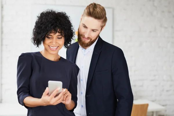 Professionals looking at smartphone — Stock Photo, Image