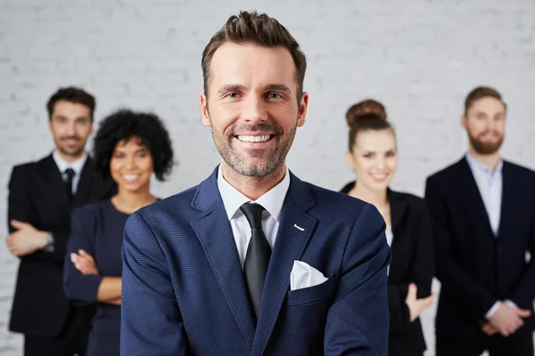 Leider staande met tevreden ondernemers — Stockfoto