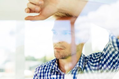 Adam bir pencereden bakan